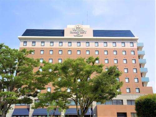 a building with a sign on the top of it at Hotel Harvest In Yonago in Yonago