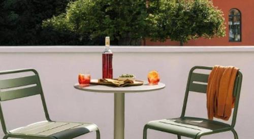 a table and two chairs with a bottle of wine at Ou Hotel in Yonago