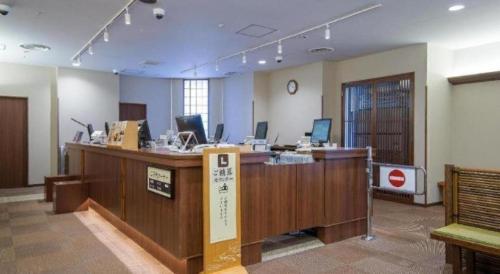 an office with a desk with a sign on it at Hadano Yugawara Onsen Manyo no Yu in Hadano