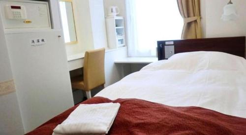 Un ou plusieurs lits dans un hébergement de l'établissement Hotel Shimbashi Sambankan