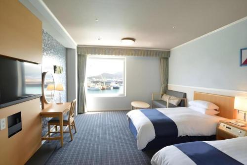 Green Hill Hotel Onomichiにあるベッド