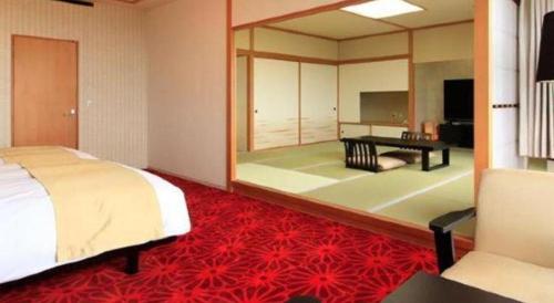 a bedroom with a bed and a large mirror at Centurion Hotel Technoport Fukui- Artificial Radium Hot Spring in Sakai
