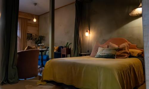 a bedroom with a bed with pillows on it at The Quarters in Strahan