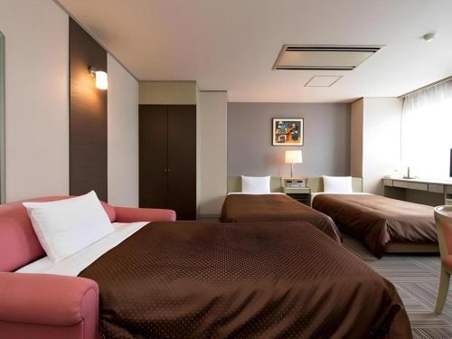 a hotel room with two beds and a couch at New Biwako Hotel in Otsu