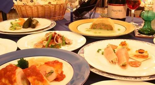 a table with plates of food on a table at Arabian Art Hotel & Gallery in Onjuku