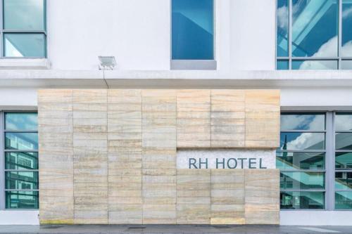 a hotel sign on the side of a building at RH Hotel Sibu in Sibu