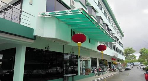 a building with red balls on the side of it at Hotel Hung Hung in Kuching