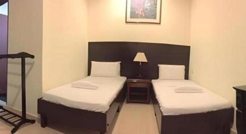 a room with two beds in a room at Perhentian Tivoli Inn in Perhentian Island