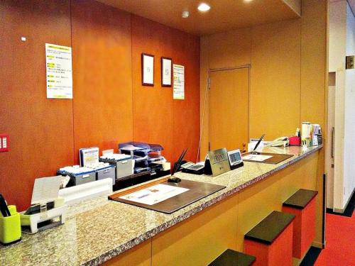 an office with a counter with computers on it at AI HOTEL OYAMA in Sano