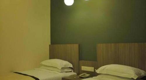 a bedroom with two beds and a phone in it at In Trend Hotel in Cukai