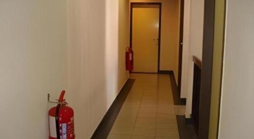a hallway with two fire hydrants and a fire extinguisher at Hotel Tuaran in Kota Kinabalu