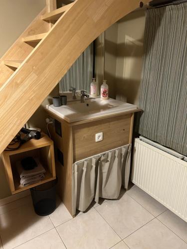 a bathroom with a sink and a wooden counter at Villa Tomasso in Eeklo