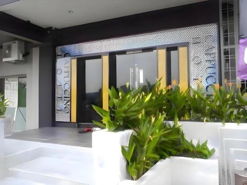 a room with plants in front of a window at Cappuccino Hotel @ Mount Austin in Johor Bahru
