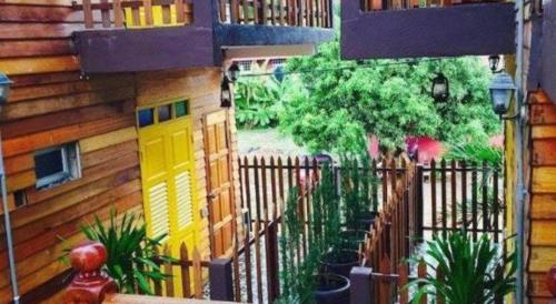 a wooden fence with a yellow door on a house at Kampong Pinang Sebatang Melaka in Melaka