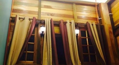 a room with some curtains in a room at Kampong Pinang Sebatang Melaka in Melaka