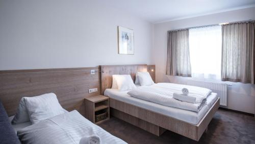 a hotel room with two beds and a window at Crystls Aparthotel in Flachau