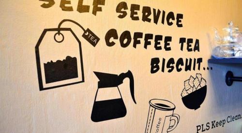 a wall with a sign for a coffee tea dispensary at THE ROOM2 @ Zishi in Kota Bharu