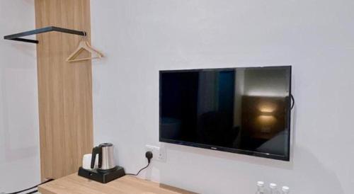 a flat screen tv hanging on a white wall at S Hotel in Johor Bahru