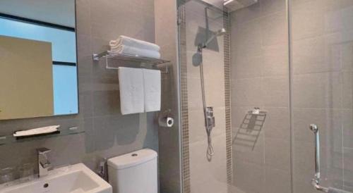 a bathroom with a shower and a toilet and a sink at S Hotel in Johor Bahru