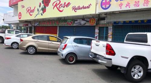 a group of cars parked in front of a store at SPOT ON 90077 Cherry's Lodge in Lahad Datu