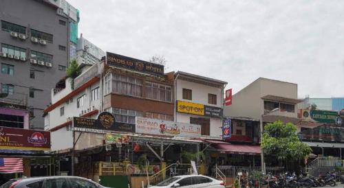 a busy city street with buildings and cars on the street at OYO 90106 Sindbad Hotel in Kuala Lumpur