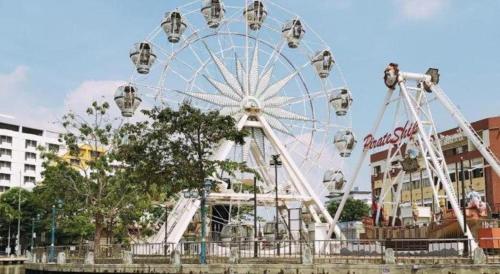 a large ferris wheel in front of a building at Hatten Place Melaka in Melaka