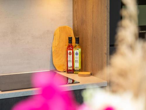 two bottles of hot sauce sitting on a counter at Unique apartment, located on the Oosterschelde and marina of Sint Annaland in Sint Annaland