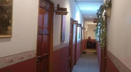 a hallway with wooden doors in a building at OYO 90785 Pandan Hotel in Kota Kinabalu