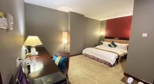 a hotel room with a bed and a desk at Shunde Emperor Hotel in Shunde