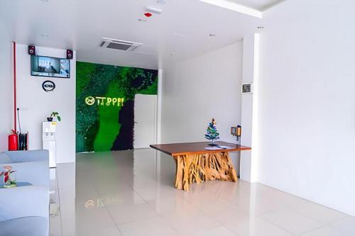 a room with a wooden table in the middle at TT Dorf Hotel (Taiping) in Taiping