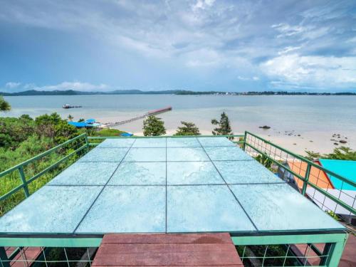 a ping pong table with a view of a beach at Dreamland Beach Holiday in Kudat