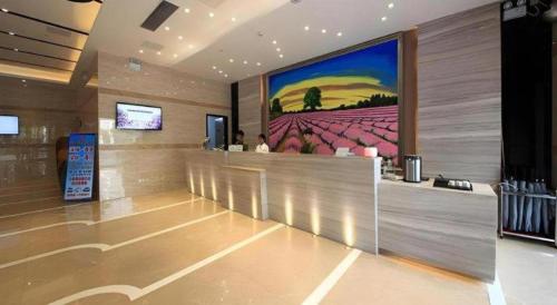 a lobby with a large painting on the wall at Shenzhen Lavande Hotel Airport Terminal Branch in Shenzhen