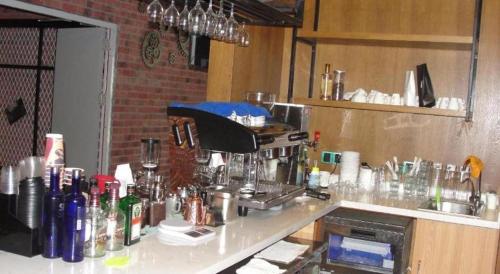 a kitchen with a counter with a coffee maker on it at James Joyce Coffetel·Shijiazhuang Economic and Technological Development Zone Chuangye Road in Shijiazhuang