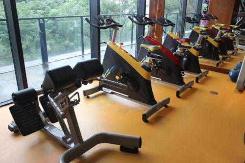 a gym with several treadmills and exercise bikes at Suzhou Qingshan Conference Center in Suzhou