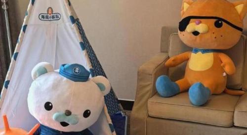two stuffed animals sitting on a chair next to a tent at Suzhou Qingshan Conference Center in Suzhou