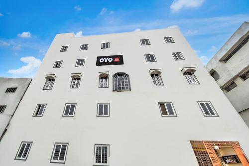 a white building with a sign on it at Hotel O Golden Paradise in Haidar Sāhibgūda