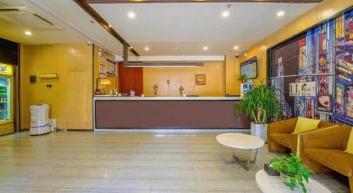 a lobby with a bar in the middle of a building at IU Hotel Taiyuan Changfeng West Street The Mixc in Taiyuan