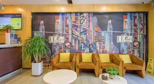 a waiting room with couches and a large mural at IU Hotel Taiyuan Changfeng West Street The Mixc in Taiyuan