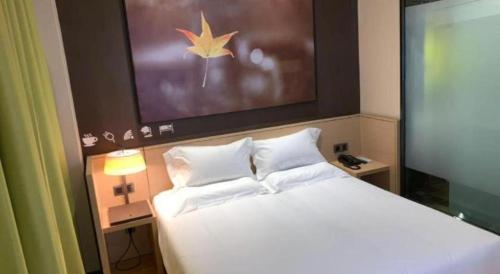a bedroom with a large bed with white pillows at IU Hotel Taiyuan Changfeng West Street The Mixc in Taiyuan