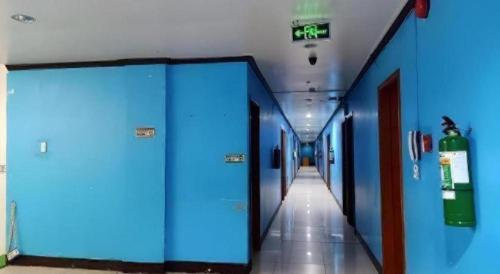 a corridor of a hospital hallway with blue walls and floors at Jeamco Royal Hotel - Pasig in Manila