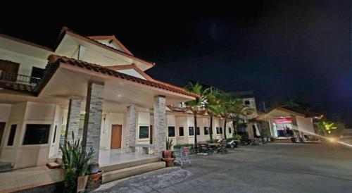 a row of houses at night at Mark Four Place Hotel in Phrae