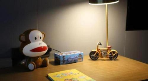 a table with a stuffed monkey and a toy car on it at Empark Grand Hotel Fuzhou in Fuzhou