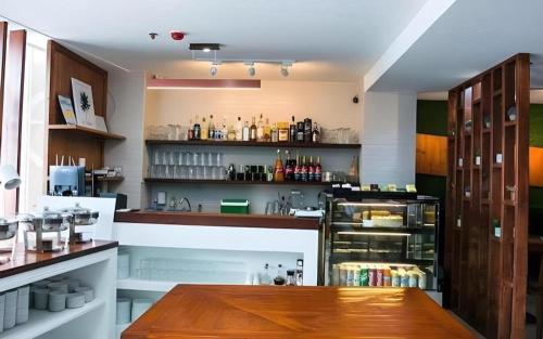 a kitchen with a counter and a table in a room at Hotel Fleur de Liz in Panglao