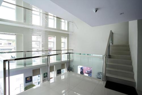 a staircase with glass railing in a building at Hotel Fleur de Liz in Panglao
