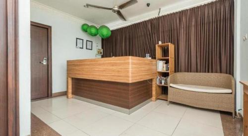 a room with a desk and a chair in a room at The Studio Inn Nusa Dua in Ubud