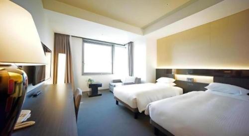 Una cama o camas en una habitación de Hotel Riverge Akebono