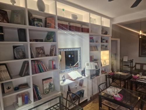 a room with a large white book shelf with books at Sweet Home Parioli in Rome