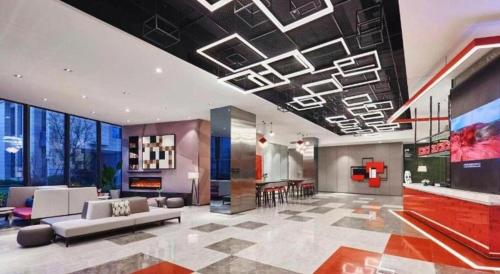 a living room with a couch and a table at Q Hotel Shanghai Pudong in Shanghai