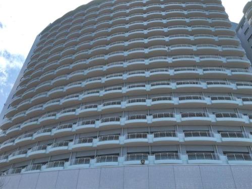 a large building with balconies on the side of it at Hotel Harvest Nankitanabe in Tanabe