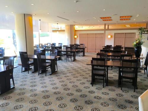 a dining room with wooden tables and chairs at Hotel Harvest Nankitanabe in Tanabe
